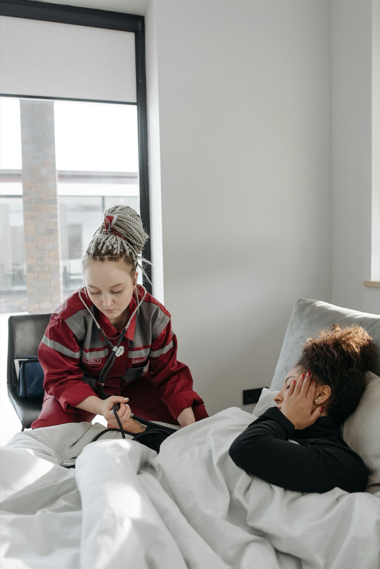 A care professional attending to a client's health needs at home
